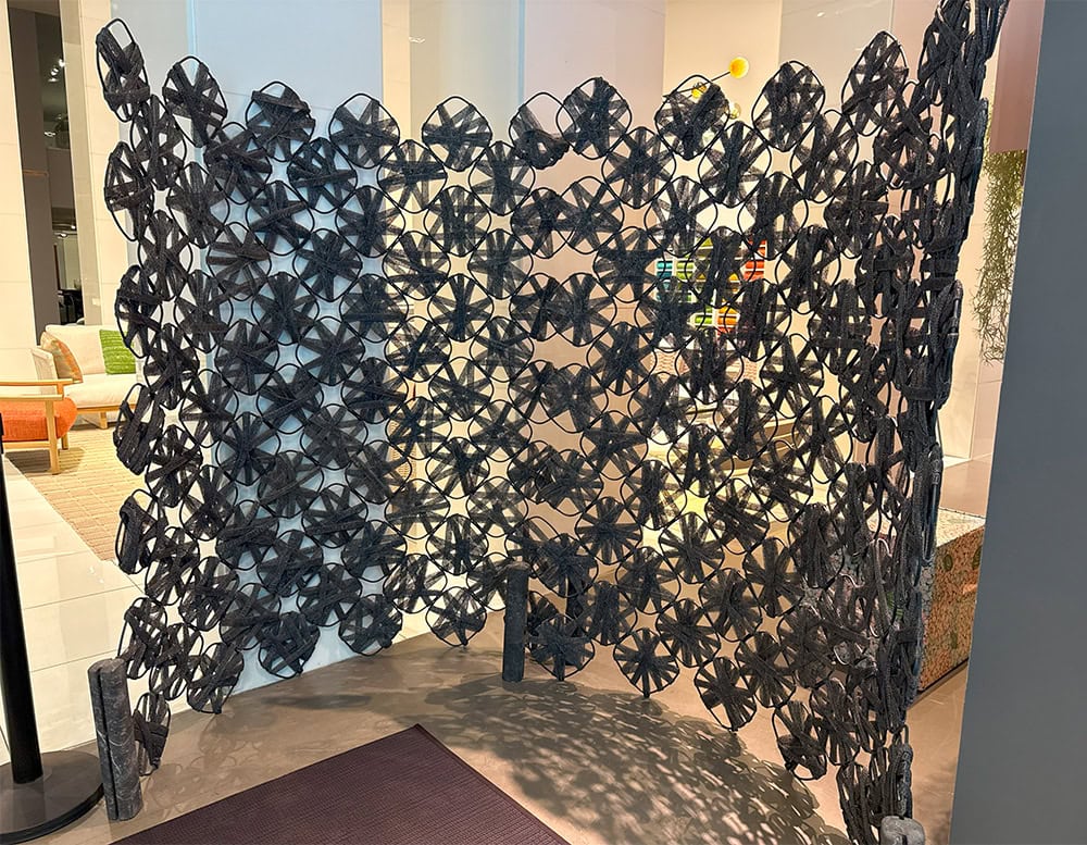 PL Rota Screen Blue features a sculptural pattern of textile petals arranged in flowing rows. Its woven modules add depth and rhythm, creating an airy partition that blurs the boundary between function and visual artistry.