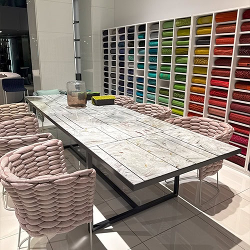 PL Sciara Outdoor Dining Table Gray features a patterned glazed surface atop a powder-coated metal frame. Paired with rope-wrapped chairs, it brings together refined textures and vibrant softness for modern indoor or outdoor settings.