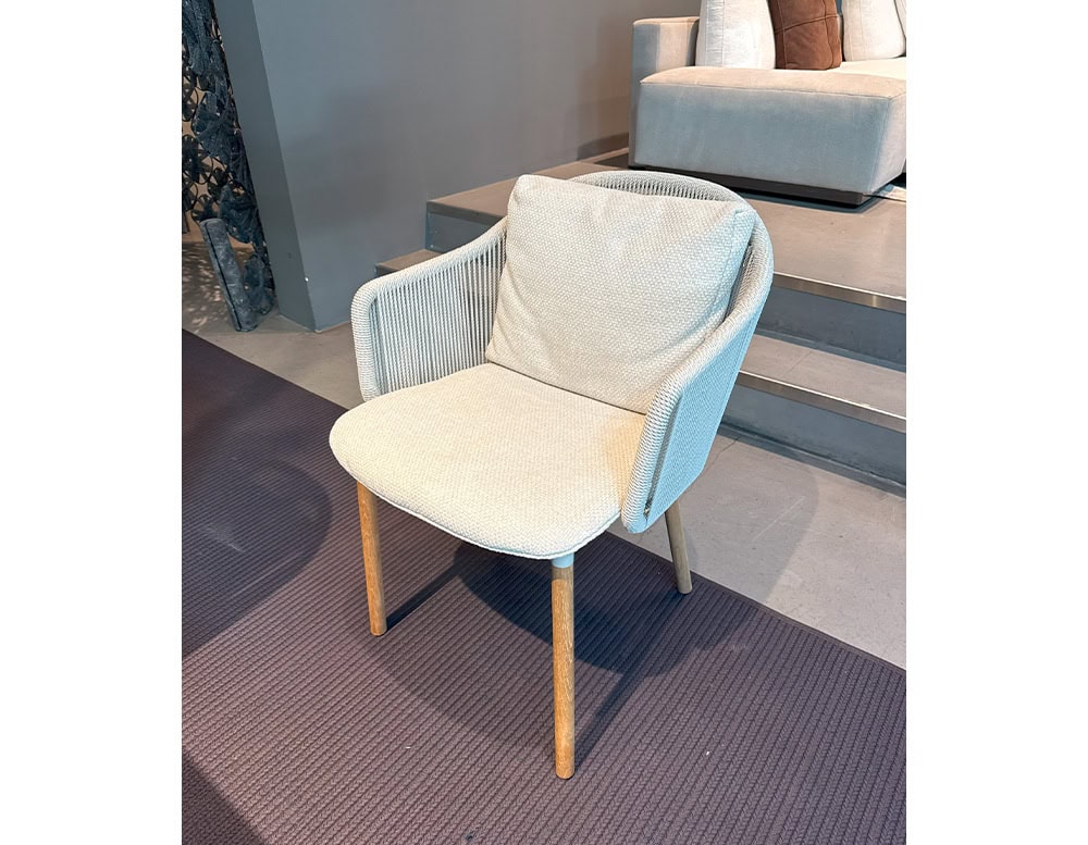 The Tri Senja Outdoor Dining Chair offers a clean elegant form with soft textured cushions and finely woven rope details. Its natural wood legs and light palette create a calm and inviting presence perfect for outdoor living.