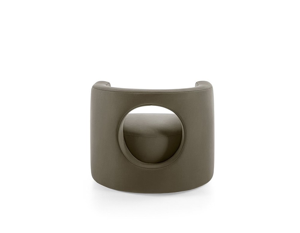 The GR H2O Lounge Chair features a rounded backrest with a central circular cut-out. Its soft, muted tone complements the chair's sculptural form.