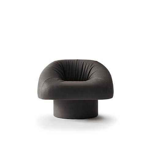 The GR Olivia Chair features an enveloping, sculptural form with plush upholstery and a cylindrical base, offering a bold yet inviting silhouette for contemporary interiors.
