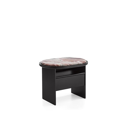 The GR Sensei Night Table presents a compact black frame with a striking marbled top in warm earthy tones. Its soft oval form combines storage and surface in a refined bedside companion.