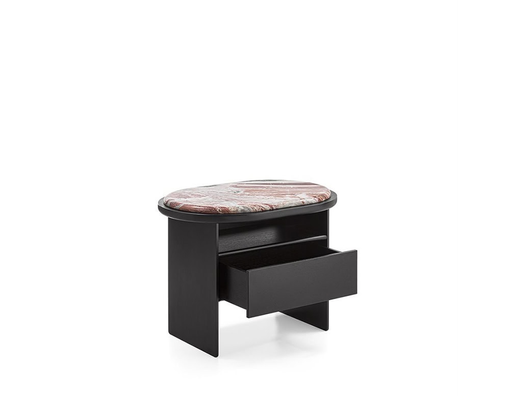 The GR Sensei Night Table combines a deep wood base with a rose marble top. Its organic, rounded form is complemented by an open shelf and drawer for discreet storage, creating a functional yet sculptural bedside piece.