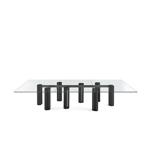 The GR Simpodio System W Coffee Table presents a modular base in dark wood with a rectangular glass top. The piece is centered in a clean, white scene, highlighting its structural balance.