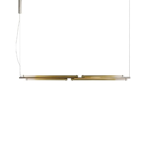 The GR Tratto Suspension Light presents a slim, horizontal composition with a quiet architectural presence. Its warm metallic tones create a soft, amber glow, bringing understated elegance to the space.