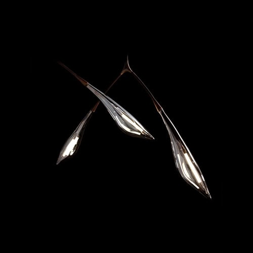 This sculptural ceiling light features a branching frame with elongated glass shades that resemble unfolding leaves. Its organic form and warm glow create an elegant focal point suited for contemporary interiors.