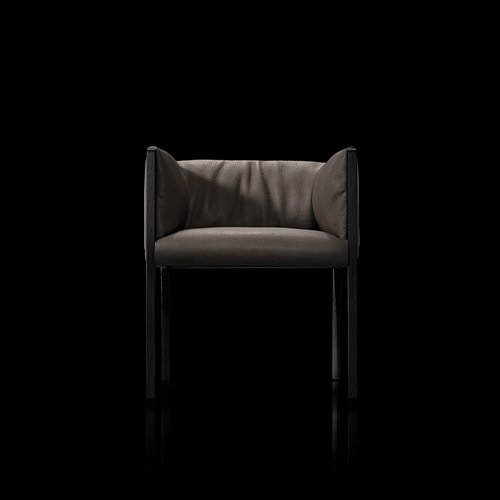 The Hen Shelly Chair pairs a deep cushion seat with low enveloping sides supported by a sleek dark wood frame, offering a blend of comfort and contemporary sophistication.