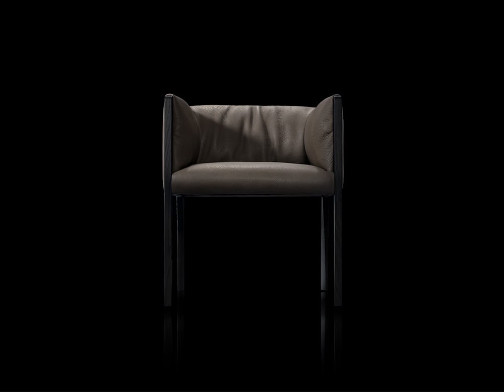The Hen Shelly Chair features plush leather upholstery cradled by a clean vertical frame, merging refined comfort with an architectural presence.