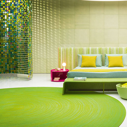 Vibrant round green rug anchors a lively outdoor setting. Paired with colorful seating and playful accents, it brings a bold, fresh energy to the space.