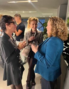 A lively exchange between attendees creates a warm and welcoming vibe.