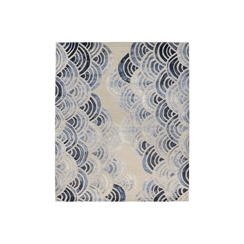 The Sah Cancun Rug features layered arcs in shades of blue and cream, inspired by ocean waves. Its dynamic pattern and soothing palette bring movement and tranquility to contemporary spaces.