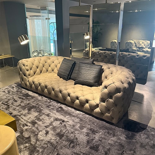 Bax Chester Moon Sofa Kaki embodies elegance with its deep button tufting and soft, luxurious upholstery. Its sculptural form and generous seating offer both sophistication and comfort, making it a refined centerpiece for modern interiors.