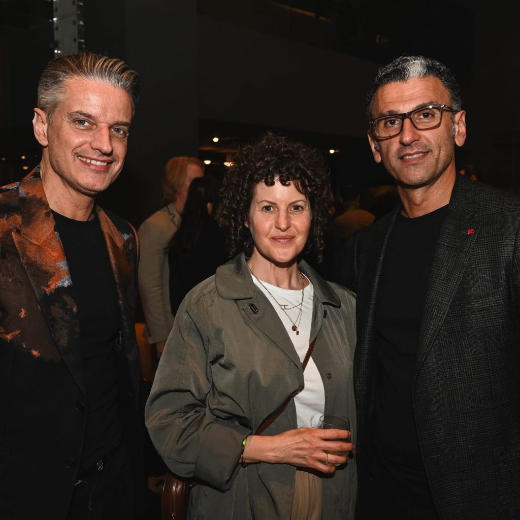 Guests gather for an elegant portrait during the evening celebration, enjoying a refined atmosphere centered around design, culture, and connection.