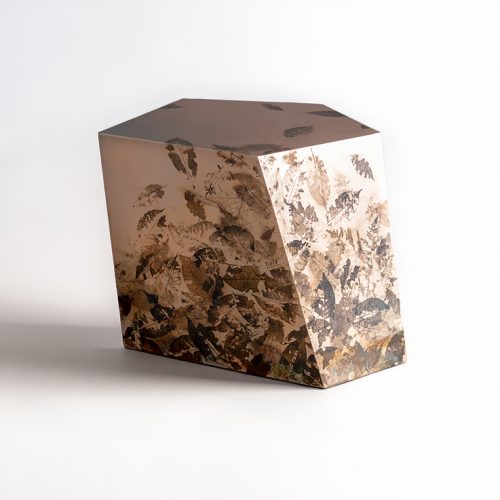 This side table features a faceted geometric form cast in translucent resin with preserved leaves and botanical fragments. Layered organic textures create depth and visual interest, balancing natural inspiration with contemporary craftsmanship.