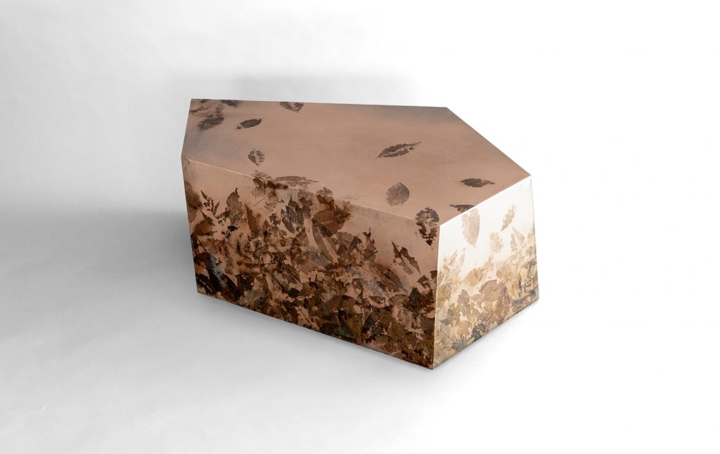 Leafprint Coffee Table features a geometric resin form embedded with preserved leaves and botanical fragments. Translucent surfaces reveal layered organic textures, creating depth and a distinctive balance between nature and contemporary design.