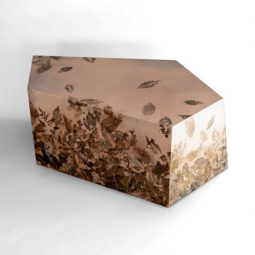 Leafprint Coffee Table features a geometric resin form embedded with preserved leaves and botanical fragments. Translucent surfaces reveal layered organic textures, creating depth and a distinctive balance between nature and contemporary design.