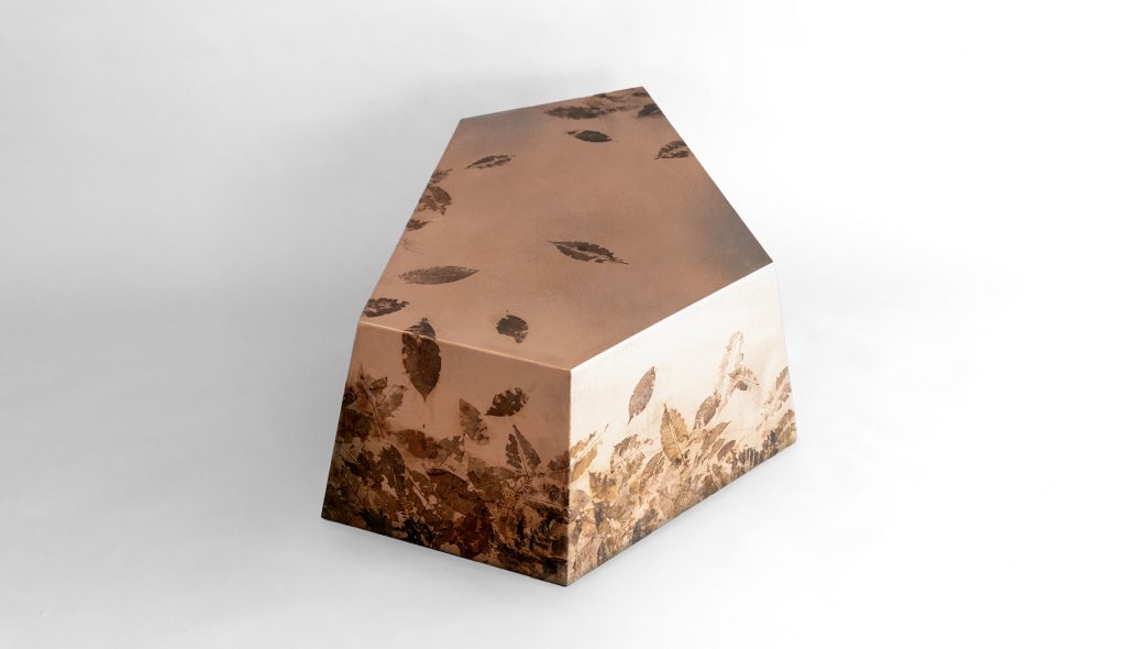 Leafprint Coffee Table combines a sculptural geometric silhouette with translucent resin embedded with preserved leaves and botanical fragments. The layered organic composition creates depth, texture, and a distinctive nature-inspired aesthetic.